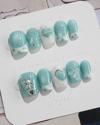 Exuma Blue extra short coffin nails with 3D hearts, jelly gloss, and silver sparkle