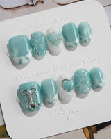 Exuma Blue extra short oval nails with pastel turquoise jelly and 3D heart details