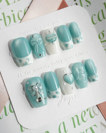 Exuma Blue short coffin nails with light blue ripples, 3D hearts, and glossy finish