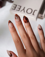 Pumpkin Patch fall tortoise press-on nails with amber swirls and gold line handmade by Joyee Nails