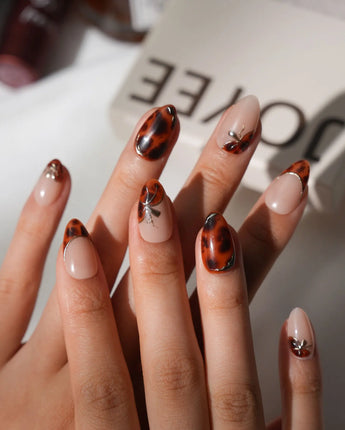 Handmade Pumpkin Patch press-on nail set with nude base amber tortoise swirls and gold accents