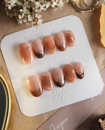 Fall Makeup press-on nails with autumn brown gradient, raised gold stars, and glossy finish