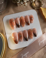 Fall Makeup press-on nails featuring caramel tones, gold wire stars, and sparkling gems