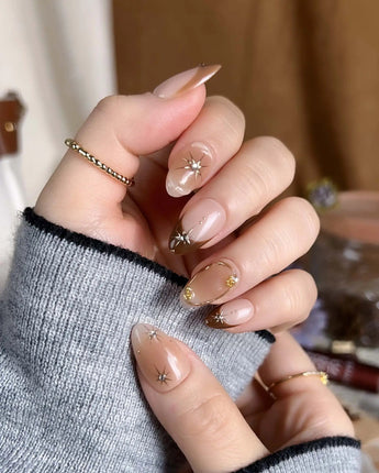 Fall Makeup press-ons with warm caramel gradient, gold wire star art, and glossy gel shine