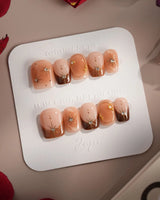 Fall Makeup press-ons with autumn brown gradient, metallic stars, and polished gel finish