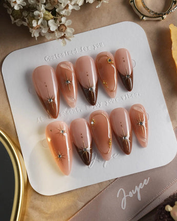 Fall Makeup press-ons with warm brown French gradient, gold stars, and tiny crystals