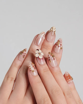 Caramel Cream press-on nails with warm brown base, sculpted flowers, and gold wire details