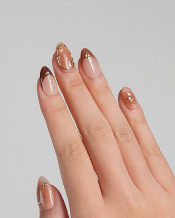 Fall Makeup nails with brown ombre base, metallic star accents, and delicate gem details