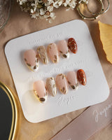 Falling leaves press-on nails with caramel autumn tones, gold vines and glossy leaf details
