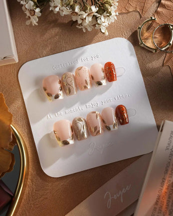 Falling leaves press-on nails with gold leaf reliefs, vine details and warm fall gel tones