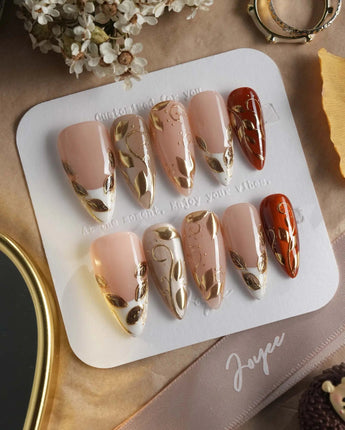 Falling leaves press-on nails with caramel autumn palette and raised gold vine accents