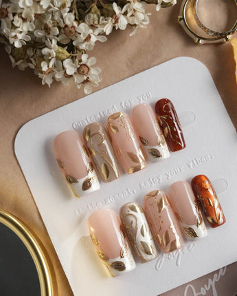 Falling leaves press-on nails with warm caramel fall colors and sculpted gold leaf details