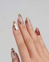 Falling leaves press-on nails with raised gold leaves, warm caramel tones and glossy finish
