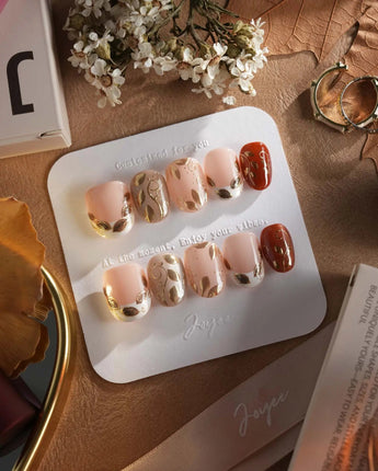 Falling leaves press-on nails with 3D gold leaves, vine accents and warm caramel base