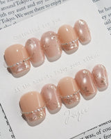 Falling Sakura-Gold nails with soft cat-eye shimmer, gold petals, and glossy finish