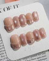 Falling Sakura-Gold nail close-up with aurora pink shine and fine gold petal accents