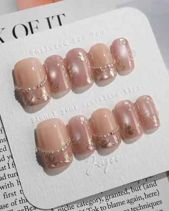 Falling Sakura-Gold nail close-up with aurora pink shine and fine gold petal accents