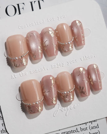 Falling Sakura-Gold press-on nails with champagne shimmer and delicate sakura-inspired art