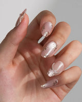 Falling Sakura-Gold nails with aurora pink cat-eye gel and hand-painted gold petals