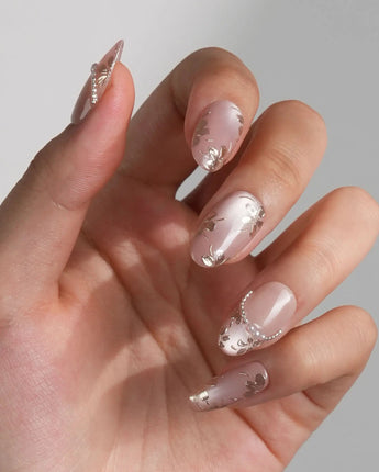 Falling Sakura-Gold nails with aurora pink cat-eye gel and hand-painted gold petals