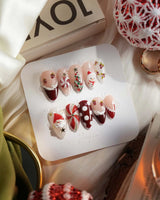 Holiday Party nail art close-up showing pearl nude cat eye snowflake bow silver glitter soft sheen details