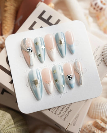 FIFA Argentina medium stiletto nails with elegant soccer theme and golden sun motifs