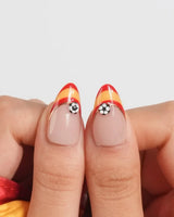 FIFA Spain reusable nails with red French tips, gold chrome lines, and soccer art