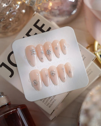 First Flake nail art close-up showing Icy Milky White & Radiant Silver, 3D Snowflake Art & Shimmering Star Accents. details