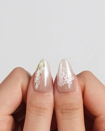 First Vow press-on nails in short almond shape — Gentle Milk Tea Nude, Hand-painted White Florals & Pearl Accents.