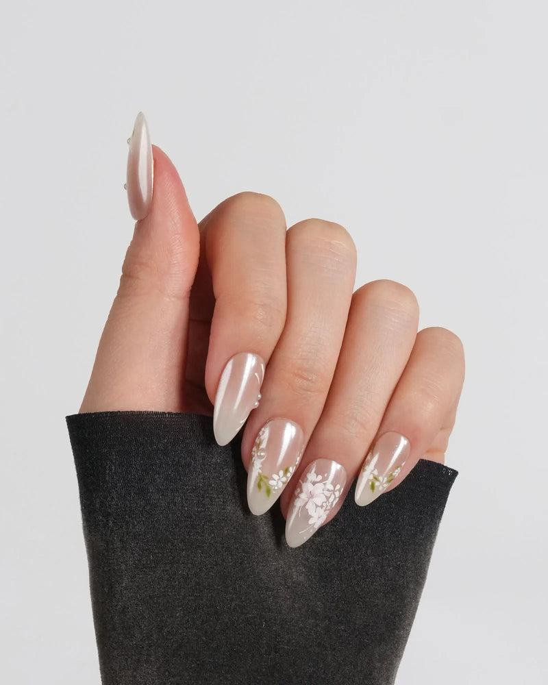 Nude pink press-on nails with white floral accents and pearl details — First Vow by Joyee Nails