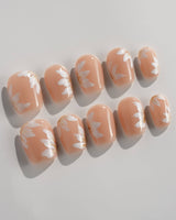 Fleur Fantasy press-on nails in medium stiletto shape — white floral french tip nails