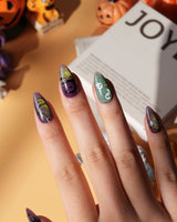 Fright Night press on nails with a fanged black cat, bats, white skulls and spider webs on purple gold and green cat eye - image 4