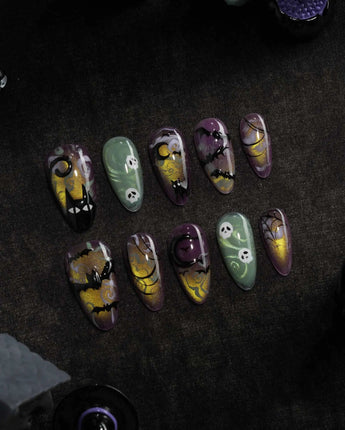 Fright Night press on nails with a fanged black cat, bats, white skulls and spider webs on purple gold and green cat eye - image 3