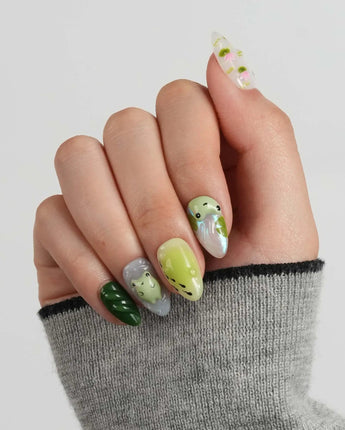 Frog Dodo custom press-on nails with tiny pond scene and glossy green gel finish