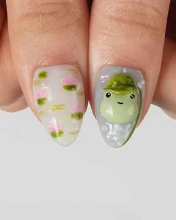 Frog Dodo watercolor-style nail set with lily pads, lotus blossoms, and 3D frogs