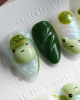 Frog Dodo extra short almond nails with green pond gradient, lotus blooms, and sculpted frogs