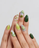 Frog Dodo close-up of frog nail art with pink lotus flowers and floating leaves