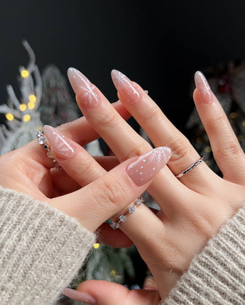 Frost Petals nail art close-up showing Sheer Nude Pink, Delicate White Snowflakes. details