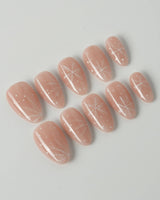 Frost Petals press-on nails in extra short almond shape — Sheer Nude Pink, Delicate White Snowflakes.