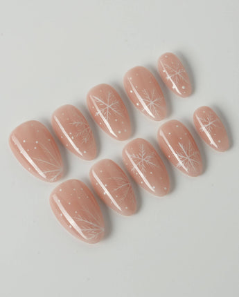 Frost Petals press-on nails in extra short almond shape — Sheer Nude Pink, Delicate White Snowflakes.