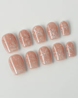 Frost Petals press-on nails in extra short coffin shape — Sheer Nude Pink, Delicate White Snowflakes.