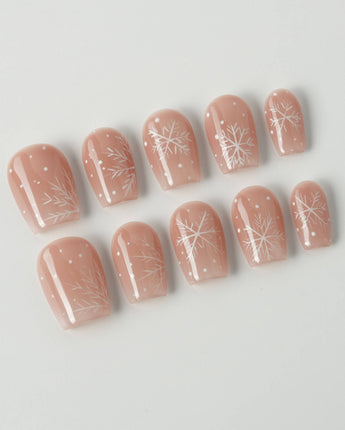 Frost Petals press-on nails in extra short coffin shape — Sheer Nude Pink, Delicate White Snowflakes.