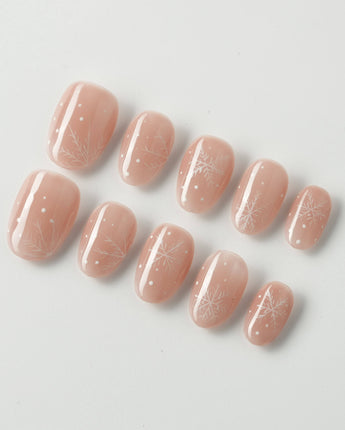 Frost Petals press-on nails in extra short oval shape — Sheer Nude Pink, Delicate White Snowflakes.
