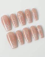 Frost Petals press-on nails in medium coffin shape — Sheer Nude Pink, Delicate White Snowflakes.