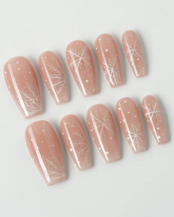 Frost Petals press-on nails in medium coffin shape — Sheer Nude Pink, Delicate White Snowflakes.