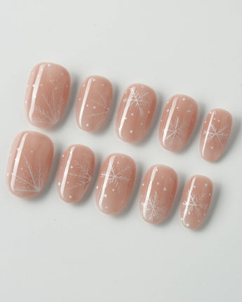 Frost Petals press-on nails in short oval shape — Sheer Nude Pink, Delicate White Snowflakes.