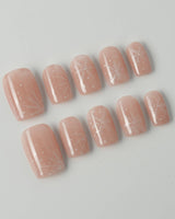 Frost Petals press-on nails in short square shape — Sheer Nude Pink, Delicate White Snowflakes.
