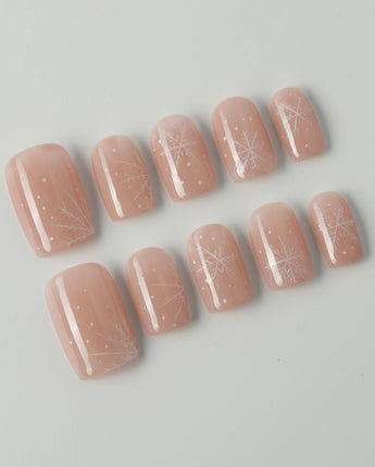 Frost Petals press-on nails in short square shape — Sheer Nude Pink, Delicate White Snowflakes.