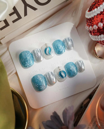 Frozen Dream press-on nails in extra short squoval shape — ice blue ombre silver chrome snowflake charm