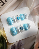 Frozen Dream press-on nails in short square shape — ice blue ombre silver chrome snowflake charm